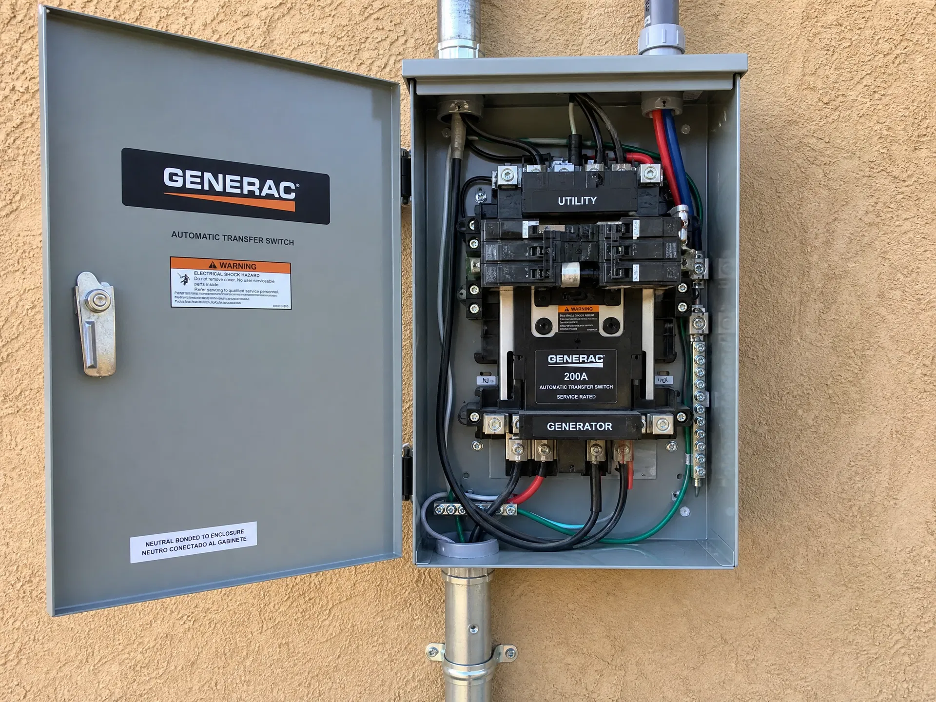 Generac 200A automatic transfer switch panel mounted on exterior wall