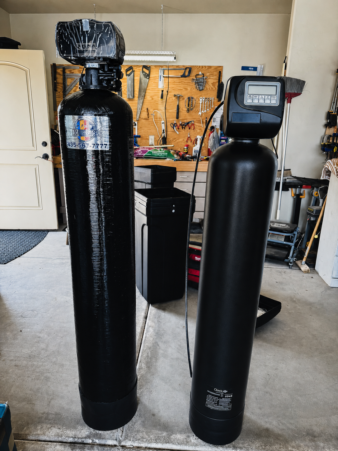 Dual water softener tanks installed in St. George, UT garage by Local Services Inc.