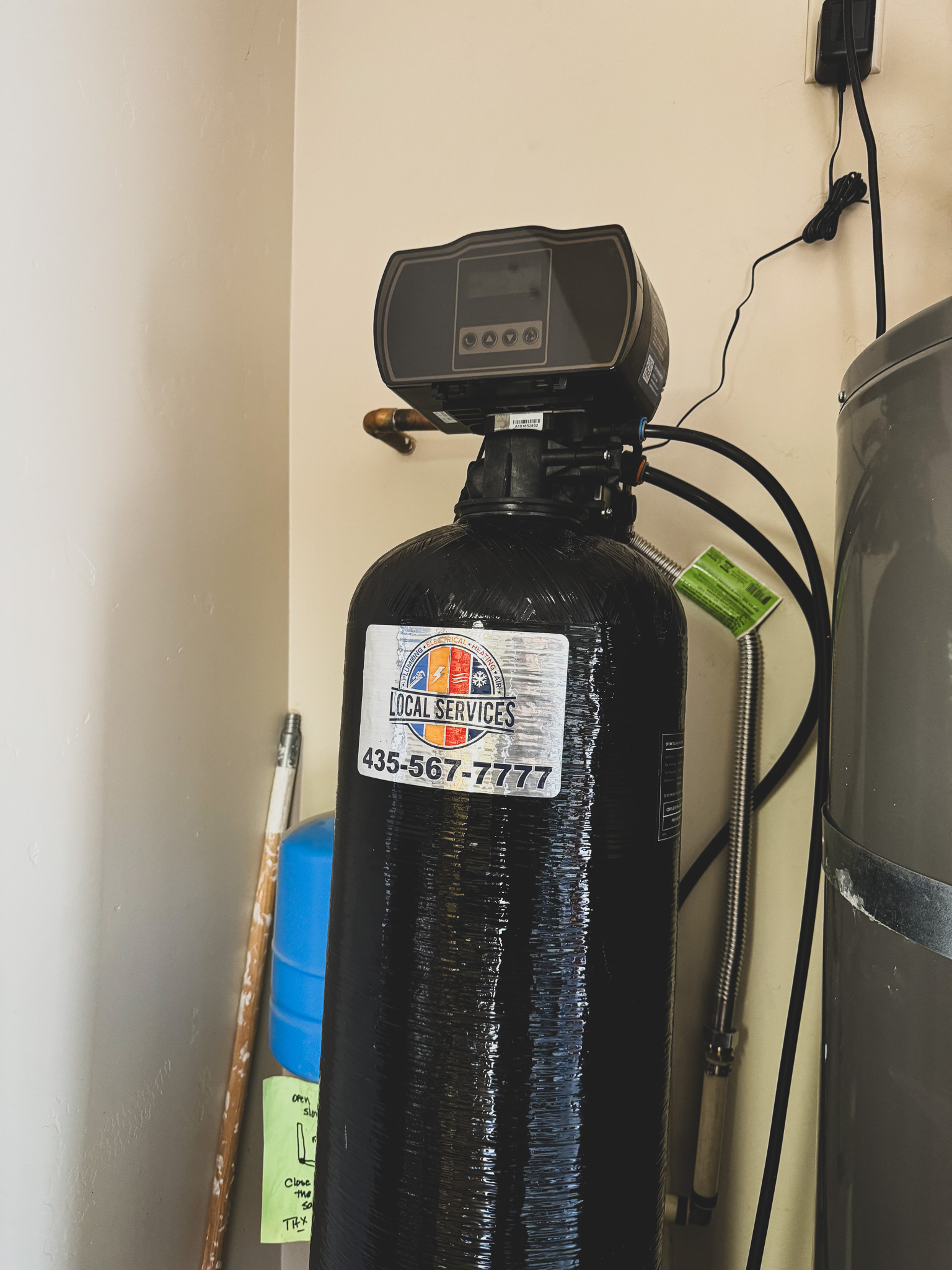 Water softener tank with Local Services Inc. sticker installed in St. George, UT